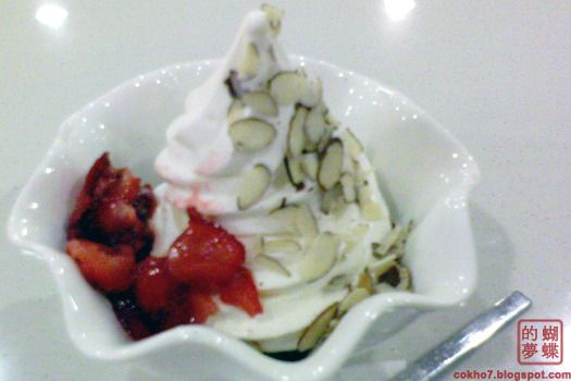 red mango frozen yogurt with strawberries and sliced almonds