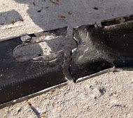 A crippled muffler bracket which no longer functions.