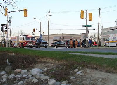 Firecrews test the asphalt after scrubbing away the blood.